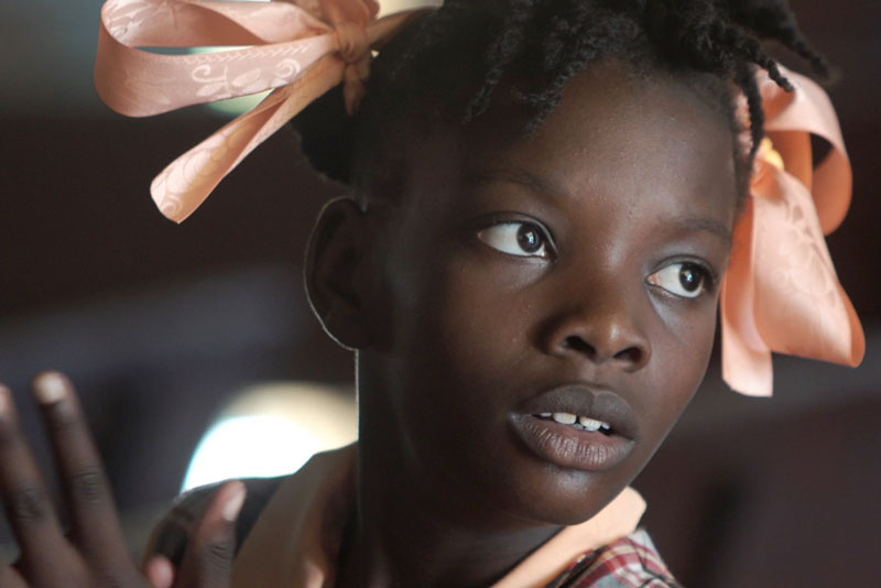 Young girl from Haiti with ribbons.