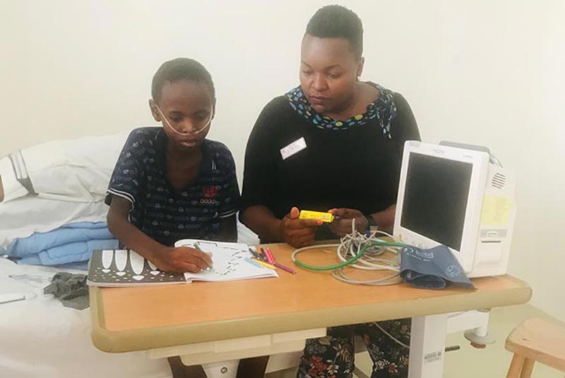 Child and caregiver in hospital in Tanzania